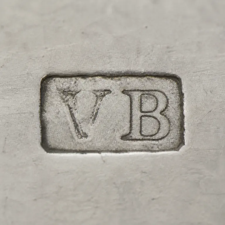 VA: VB in two compact worn capitals inside one rectangular cartouche, faint V retained as broken strokes; oxidized reconstruction.