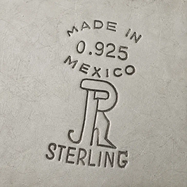 Juvento Lopez Reyes: One vertically arranged mark reads MADE IN, 0.925, and MEXICO above a large intertwined JR-like monogram, with STERLING below; oxidized reconstruction.