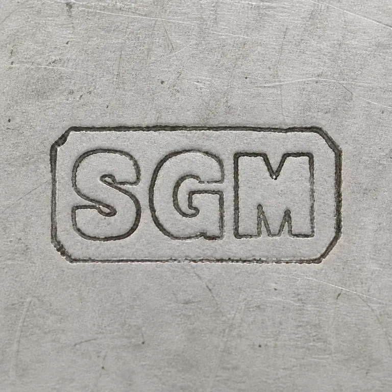 Sylvia Grace Murphy: S G M arranged left to right inside one clipped-corner rectangular cartouche; oxidized reconstruction.