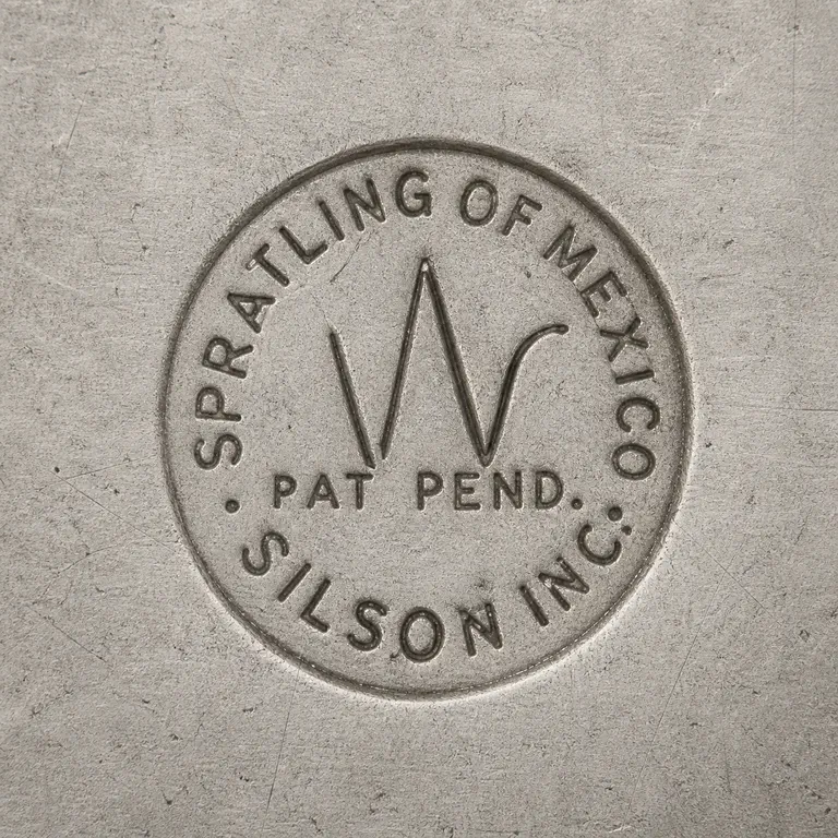 Silson Mark: One circular Silson mark preserves SPRATLING OF MEXICO, PAT PEND, the central device, and SILSON INC in source order; oxidized reconstruction.