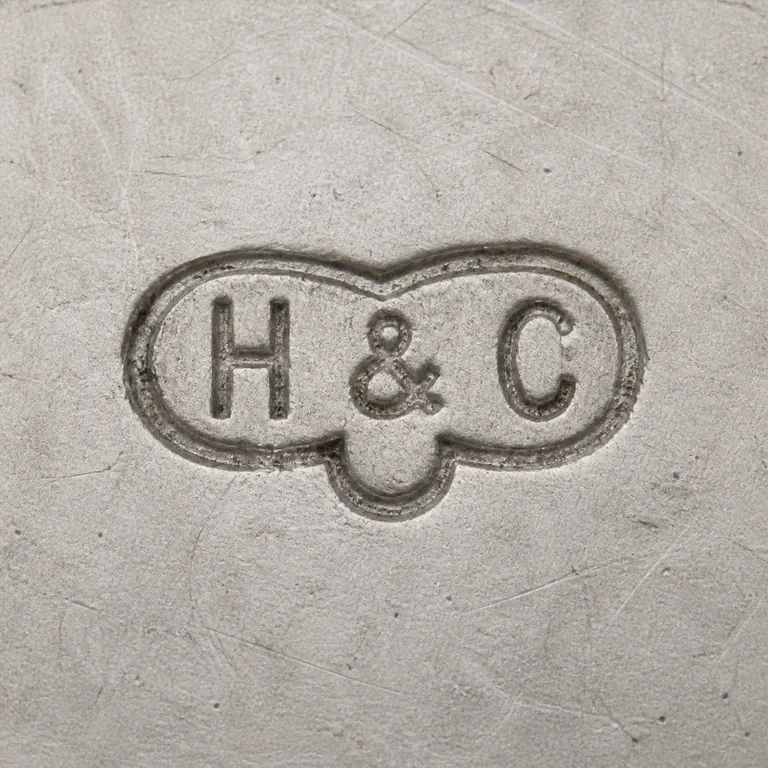 Hamilton & Co (of: Source-bounded low-confidence contour preserves the visible mark geometry and supported lettering or device; oxidized reconstruction.