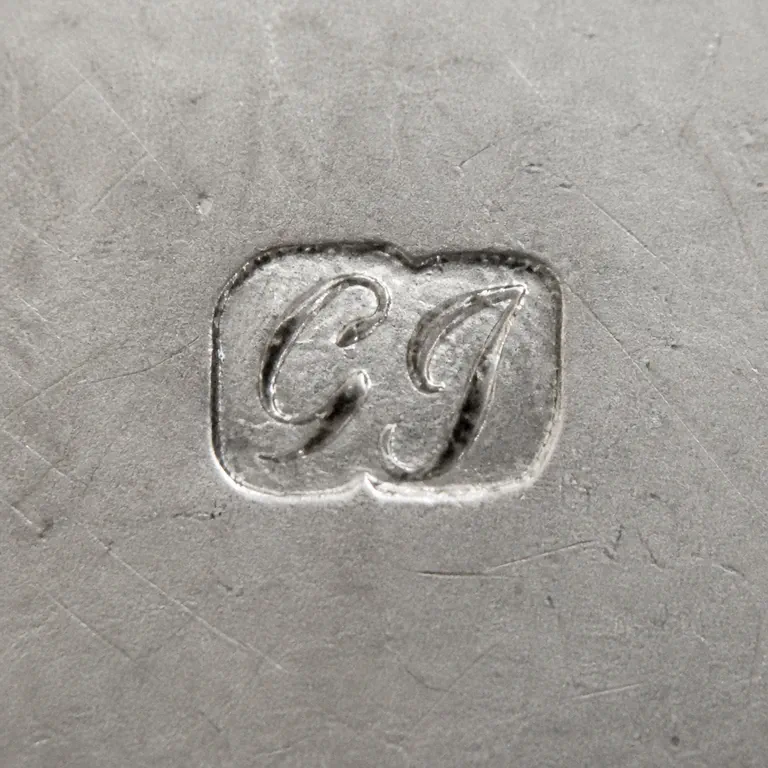 George Greenhill Jones: Preserves two G/J-like forms inside one worn rounded cartouche; oxidized reconstruction.